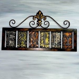 Metal plaque with the word Family on it. Looks like bronze and silver colors.